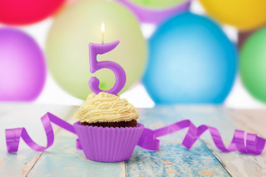 Cupcake with candle with number 5 on it