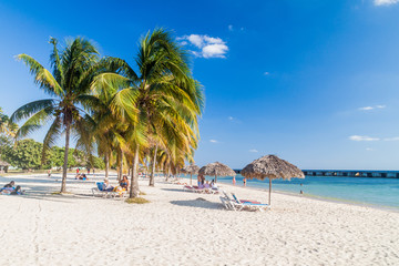 PLAYA GIRON, CUBA - FEB 14, 2016: Tourists at the beach Playa Giron, Cuba. This beach is famous for...