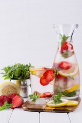 Fruit and herb infused water. Cold refreshing vitamin detox water. Summer drink