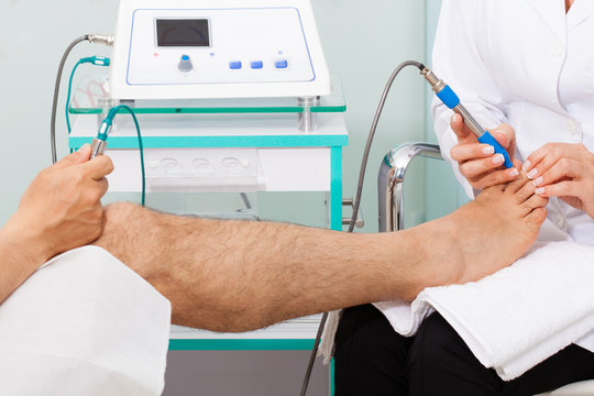 Doctor Using Electro Acupuncture Equipment For Diagnostic