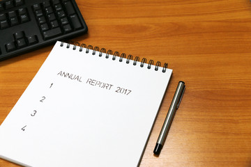 Annual report 2017 on paper milestones aligned on the desk .are representative of success in the past and goal for the future in this 2018