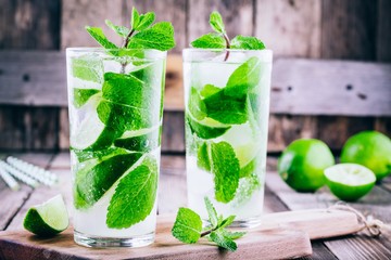 fresh mojito cocktails with lime, mint and ice in glass