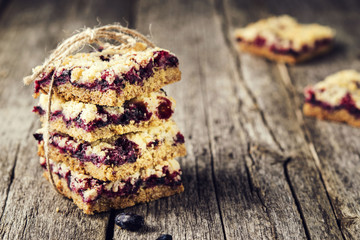 Homemade honeysuckle crumble bars, sliced crumb cake on vintage wooden table. Healthy desert....