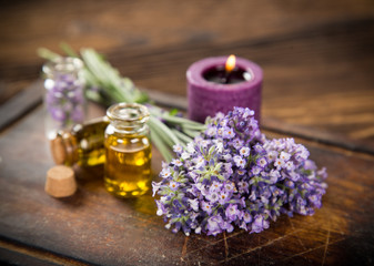 Plakat Wellness treatments with lavender flowers on wooden table.