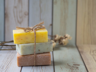 Natural bar soaps on pastel colour table, for herbal spa and cleansing