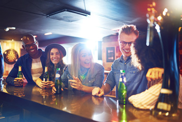 Joyful people drinking beer in the tavern