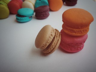 the colorful macaroons in vintage design,soft tone ,pastel style,art design,blurry light around.