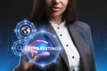 The concept of business, technology, the Internet and the network. A young entrepreneur working on a virtual screen of the future and sees the inscription: Remarketing