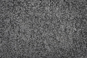 Dark grey asphalt background texture close up
