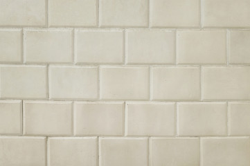 Old beige tile brick wall background texture