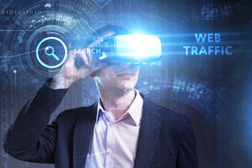 Business, Technology, Internet and network concept. Young businessman working in virtual reality glasses sees the inscription: Web traffic