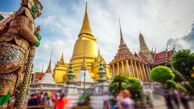 Golden stupa or chedi of Wat Phra Kaew also known as the Temple of the Emerald Buddha at the Grand Palace in Bangkok, Thailand (faces blurred for commercial use)