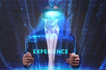 Business, Technology, Internet and network concept. Young businessman working in virtual reality glasses sees the inscription: Experience