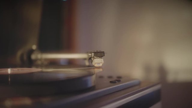 Close up of a record player playing vinyl. Retro vinyl turntable playing a black 33 rpm vinyl record. 4k footage