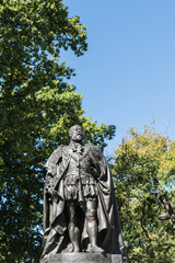 Fototapeta na wymiar Hobart, Australia - March 19. 2017: Tasmania. Closeup of bronze statue of King Edward VII shows him looking proudly and defiant. Green park background and blue sky.