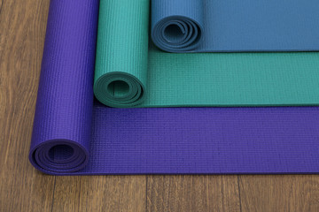 Three different coloured yoga mats