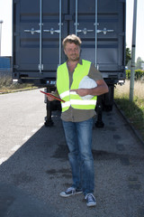 man with container and truck in fret area