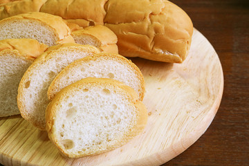 fresh bread slide on wood cutting board