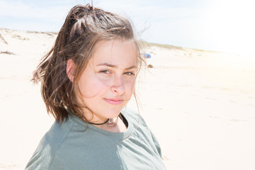 cheerful girl on sand beach smile wearing shirt