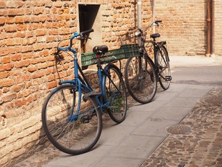 Fototapeta na wymiar Bicycles leaning against a brick wall