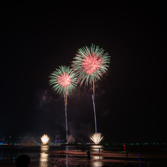 Beautiful firework display on celebration night, showing on the river   