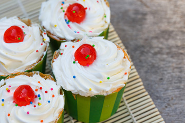 Delicious cupcake on the wooden floor