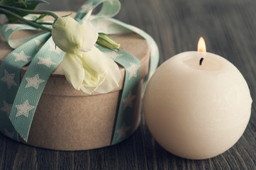 Fototapeta na wymiar Gift box with star ribbon on dark rustic table