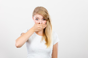 Ashamed woman having hand on mouth