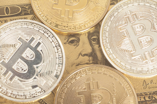 Golden  and silver bitcoin  with U.S. dollar