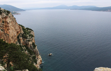 Panoramic view of the blue Mediterranean sea from the highest point of a cliff in Sardinia 