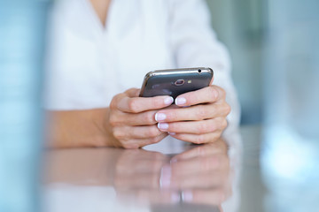Closeup of woman' s hand using smartphone