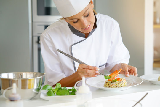 Chef preparing dish in professional kitchen