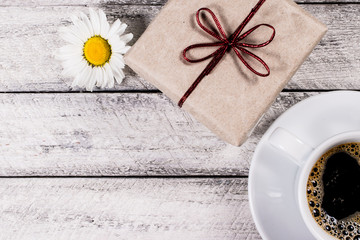 Present box onwooden background. greeting card holidays concept.