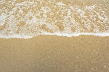 Soft wave of the sea on sandy beach.