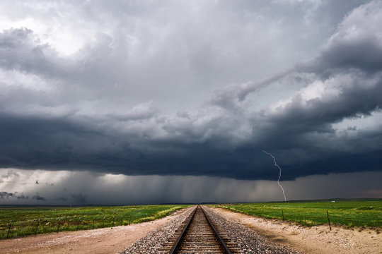 Dark stormy sky over railroad tracks
