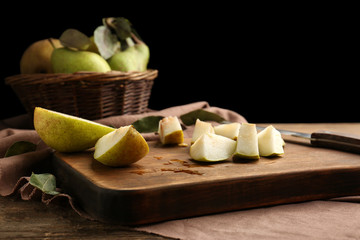 Sliced pear on wooden board