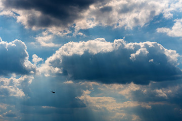 Naklejka na ściany i meble Small silhouette of an airplane flying
