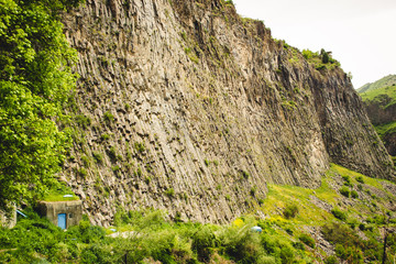 Mountain landscape with unique geological formation called Symphony of Stones. Basalt rock. Ecotourism. Nature background. Adventure holiday. Armenia, Garni. Travel vacation. Climbing tourism concept