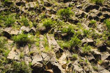 Mountain unique geological formation called Symphony of Stones. Basalt rock. Ecotourism. Nature background. Adventure holiday. Armenia, Garni. Travel vacation. Climbing tourism concept. Stone texture
