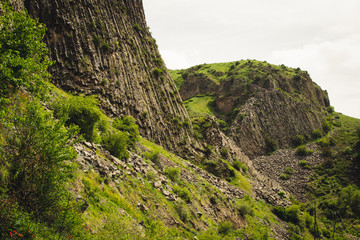 Mountain landscape with unique geological formation. Basalt rock. Ecotourism. Nature background. Adventure holiday. Armenia, Garni. Travel vacation. Climbing tourism and hiking concept. Beauty world