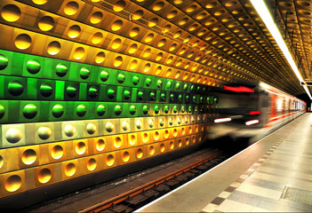 Railway station with modern high speed red metro chasing underground station with motion blur effect.
