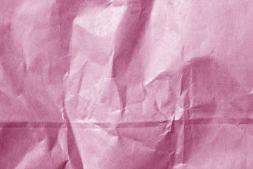 wrinckled pink color paper surface.