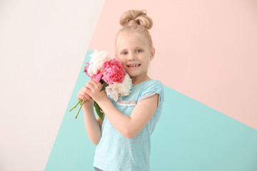 Cute funny girl with bouquet of flowers on color background