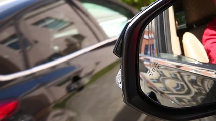 Blind Spot Monitoring system warning light icon in side view mirror of a modern vehicle. system blind spots of the car
