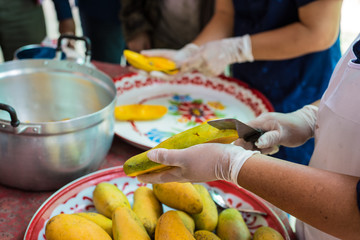 Chef is peeling mango