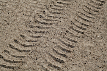 Car tracks on sandy dune.