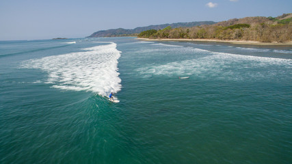 Aerial view of a surfer on a wave in Santa Teresa, Costa Rica