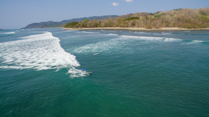 Aerial view of a surfer on a wave in Santa Teresa, Costa Rica
