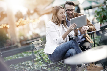 Couple at Bryant park using digital tablet