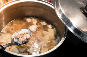 Clear Soup, bamboo shoots and pork in a pot in a bucket.